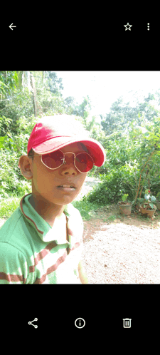a young boy wearing a red hat and red sunglasses