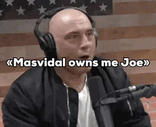 a man wearing headphones is sitting in front of a microphone and talking into it .