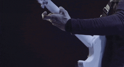 a man is playing a guitar with a robotic arm and the words oddmaster are visible in the corner