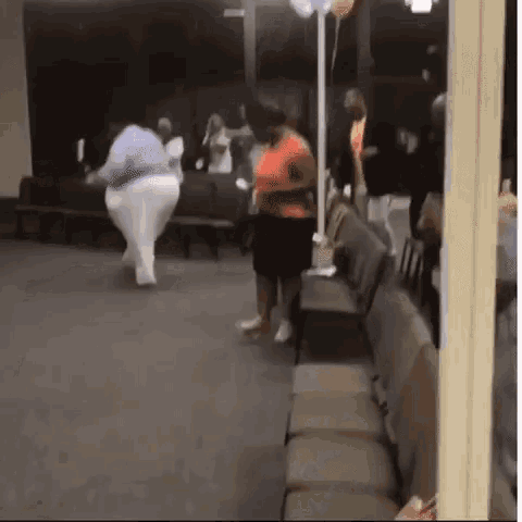 a group of women are dancing in a room with balloons .