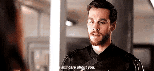 a man with a beard is talking to a woman and saying `` i still care about you . ''