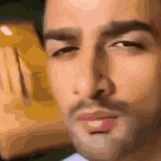 a close up of a man 's face with the eyes closed