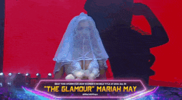 a woman in a wedding dress is standing on a stage with a sign that says the glamour mariah may