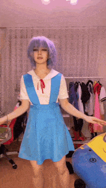 a girl with blue hair is wearing a blue dress and a white shirt .