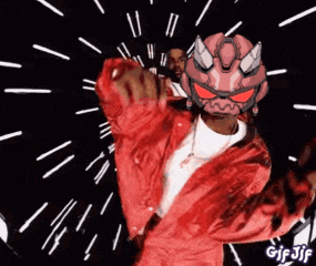 a man in a red jacket is wearing a devil mask