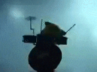a silhouette of a person playing a piano in a dark room with a blue background