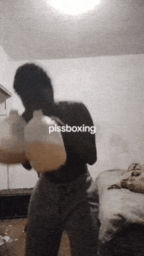 a man wearing boxing gloves with the word pissboxing written on it