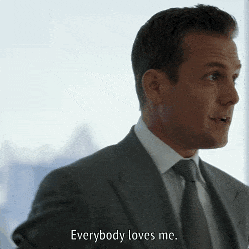 a man in a suit and tie says that everybody loves me