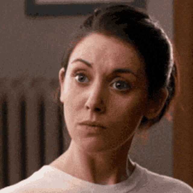a close up of a woman 's face making a funny face