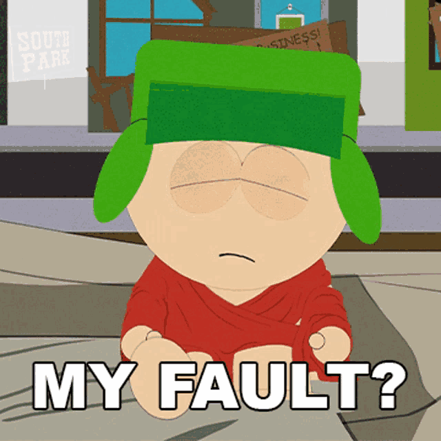 a cartoon character with a green hat is sitting on the ground and says " my fault "