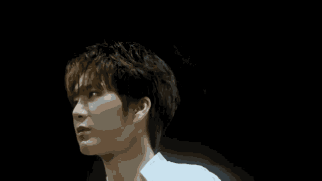 a young man in a white shirt is looking up