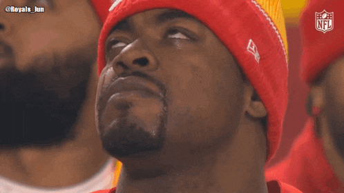 a man wearing a beanie with a nfl logo on it
