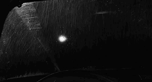 a black and white photo of a tornado hitting a car windshield .