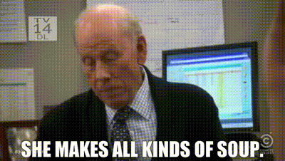 a man in a suit and tie is sitting in front of a computer screen and says she makes all kinds of soup .