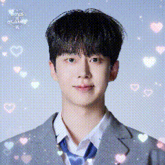 a young man in a suit and tie is surrounded by hearts and sparkles .