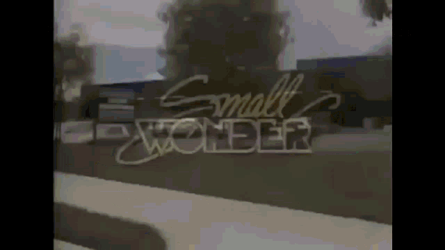 a small wonder sign is displayed in a blurry photo