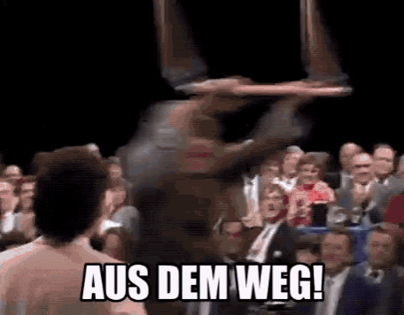 a group of people sitting in a dark room with the words aus dem weg