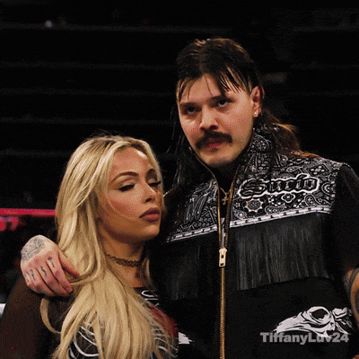 a man and a woman are posing for a picture and the man is wearing a jacket that says enjoi