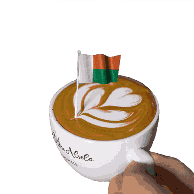 a cup of cappuccino with a flag on top of it