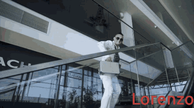 a man is walking down stairs with lorenzo written on the bottom