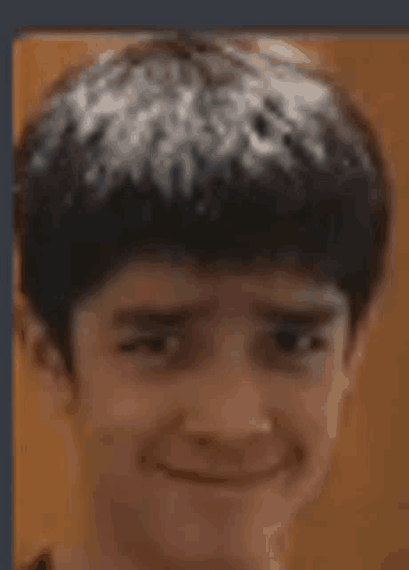 a close up of a young man 's face with a slight smile on his face .