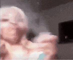a blurry picture of a woman holding a bottle