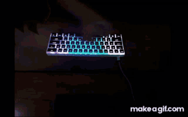 a person is typing on a keyboard with makeagif.com in the corner