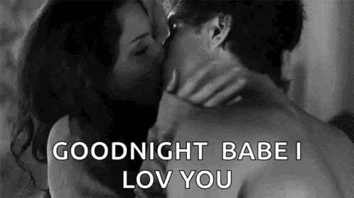 a man and a woman are kissing in a black and white photo with the words `` goodnight babe i love you '' .
