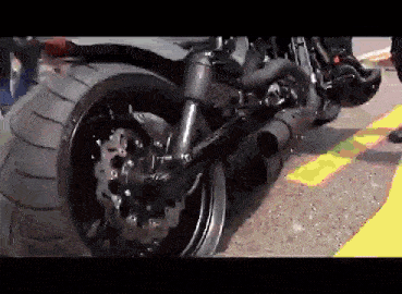 a motorcycle with a large tire is parked on the street