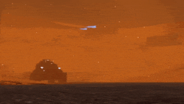 a bunch of military vehicles are driving down a road