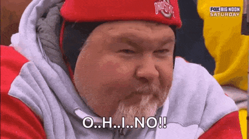 a man with a beard is wearing a red hat and a sweatshirt and says o.h.i. no !