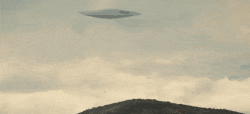 a ufo is flying over a mountain with trees on it