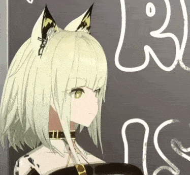 a girl with fox ears is standing in front of a blackboard with a drawing of a snake on it .