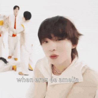 a woman with short hair is standing in front of a group of people and says when eres de amelia .