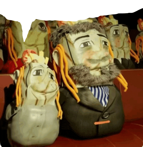 a man with dreadlocks and a suit is sitting next to another man