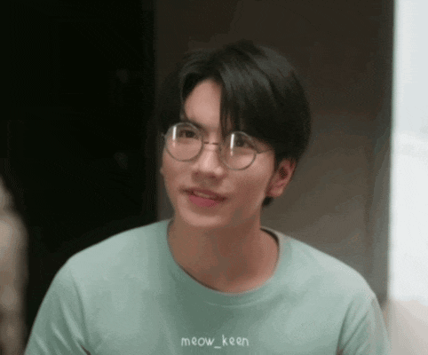 a young man wearing glasses and a meow_keen shirt