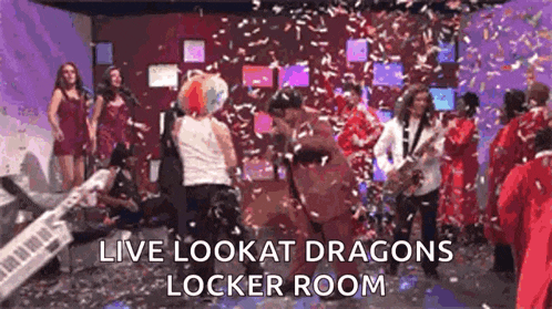 a group of people are dancing in a room with confetti falling and the words `` live lookat dragons locker room '' .
