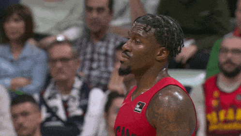 a basketball player wearing a red jersey that says miami