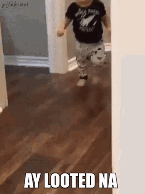 a baby is running in a hallway with the words ay looted na written on it
