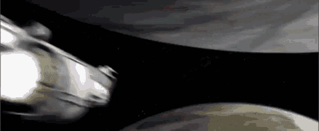a space ship is flying over a planet in space