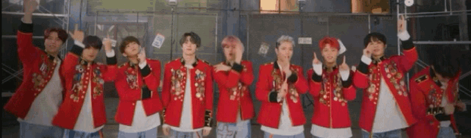 a group of young men in red jackets are standing next to each other and giving a thumbs up
