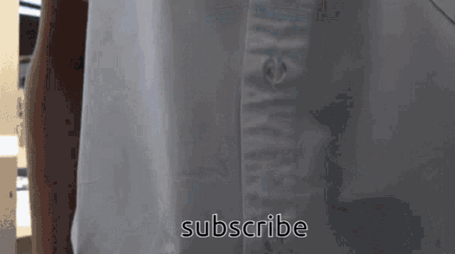 a close up of a white shirt with the words subscribe on it