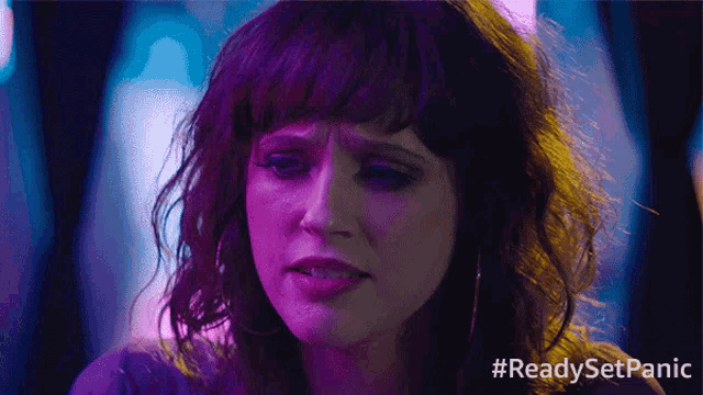 a close up of a woman 's face with #readysetpanic written in the corner