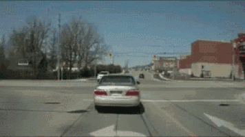 a congratulations poster with a car crash in the foreground