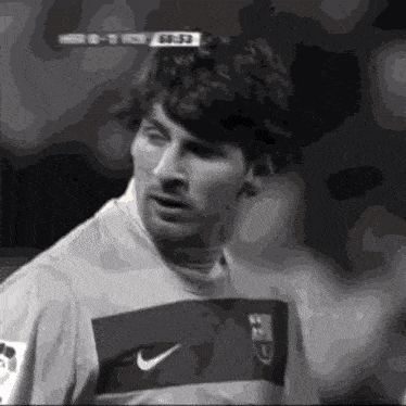 a black and white photo of a soccer player wearing a nike jersey