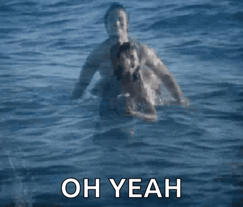 a man and a woman are swimming in the ocean with the words oh yeah written on the bottom