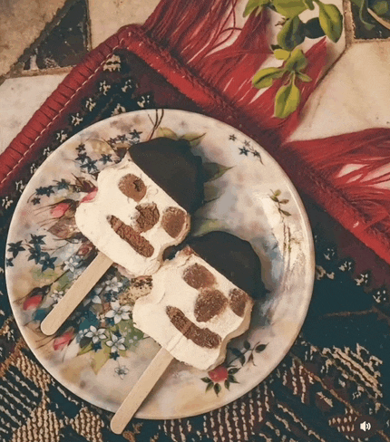 two ice cream bars on a plate with a floral pattern