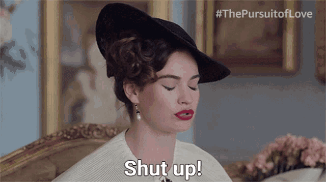 a woman wearing a black hat and white jacket says shut up