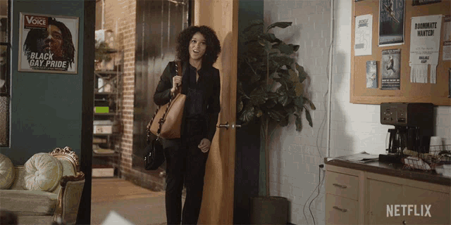 a woman standing in front of a door with a netflix logo on it
