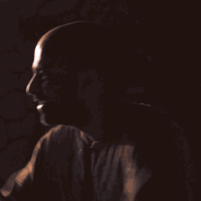 a silhouette of a person standing in front of a window with the sun shining through it